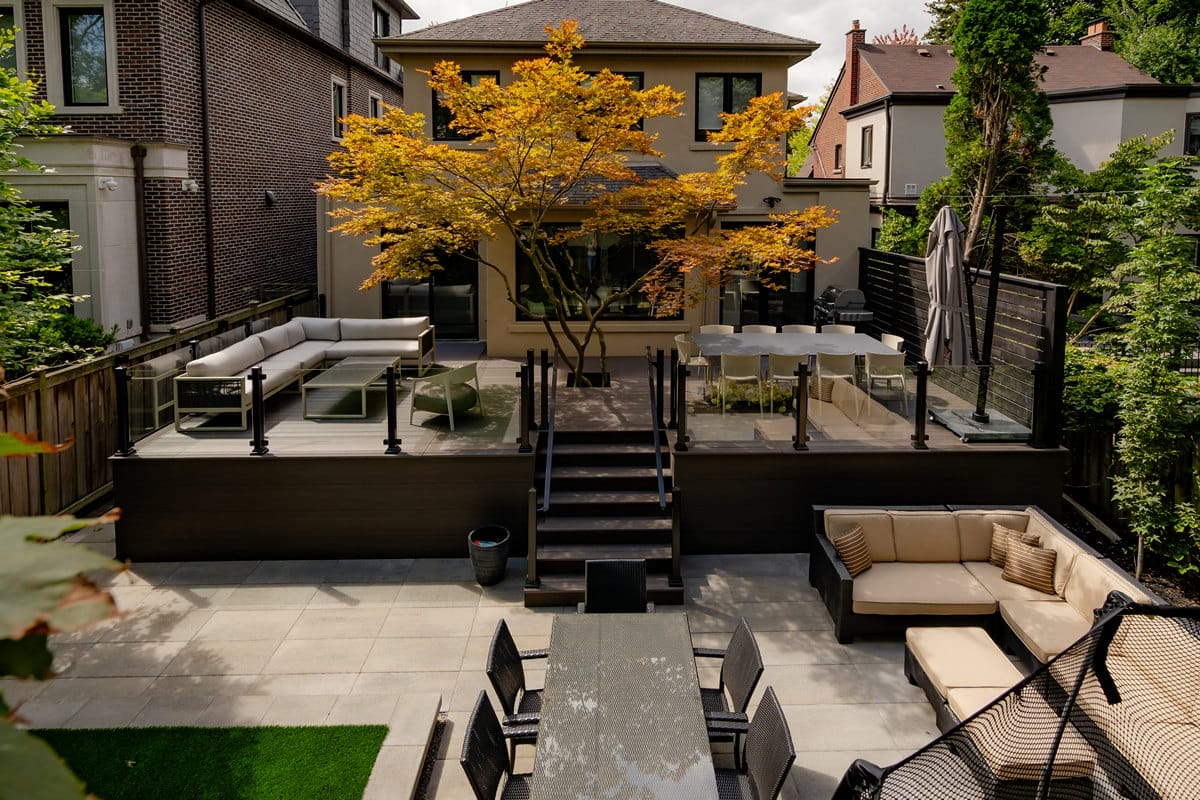 Deck building with glass railings installed at Glenayr Rd, Toronto, landscaping project