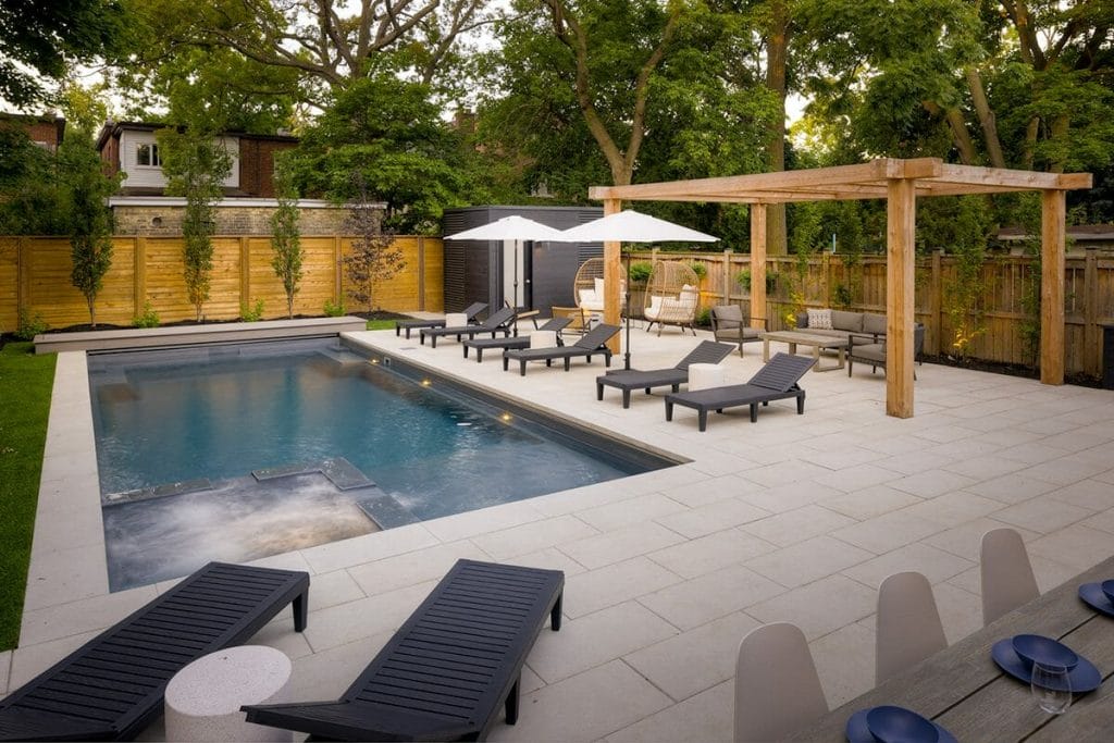 Completed Small Backyard Modern Landscape Design Project; Featuring Patio Design, Stone Interlocking, Woodworking Pergola, Fiberglass Pool Installation with MIni Swim Spa, And Outdoor Fireplace