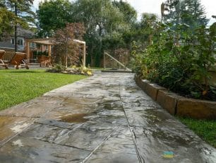 M.E. Contracting did this backyard landscaping project in Toronto. It includes interlocking stone walkways, a cedar pergola and tempered glass railings with stainless steel posts and clips.