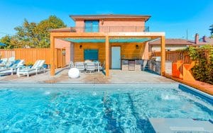 Landscape Design & Pool Construction Project with Woodworking Pergola, Water Features, Interlocking & Outdoor Firepit by The Toronto Landscaping Company.