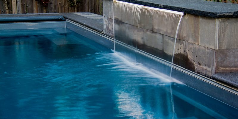 Small Toronto backyard Fiberglass Pool building With Water Feature by pool construction Company.