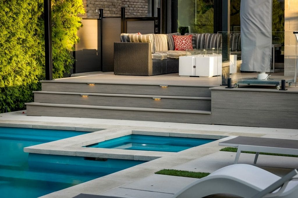 Toronto Landscape Design and Construction Project by M.E. Contracting, Featuring Stone Interlocking Patio, Swim Spa and Pool Installation, PVC Decking with Outdoor Lighting and Aluminum Railings