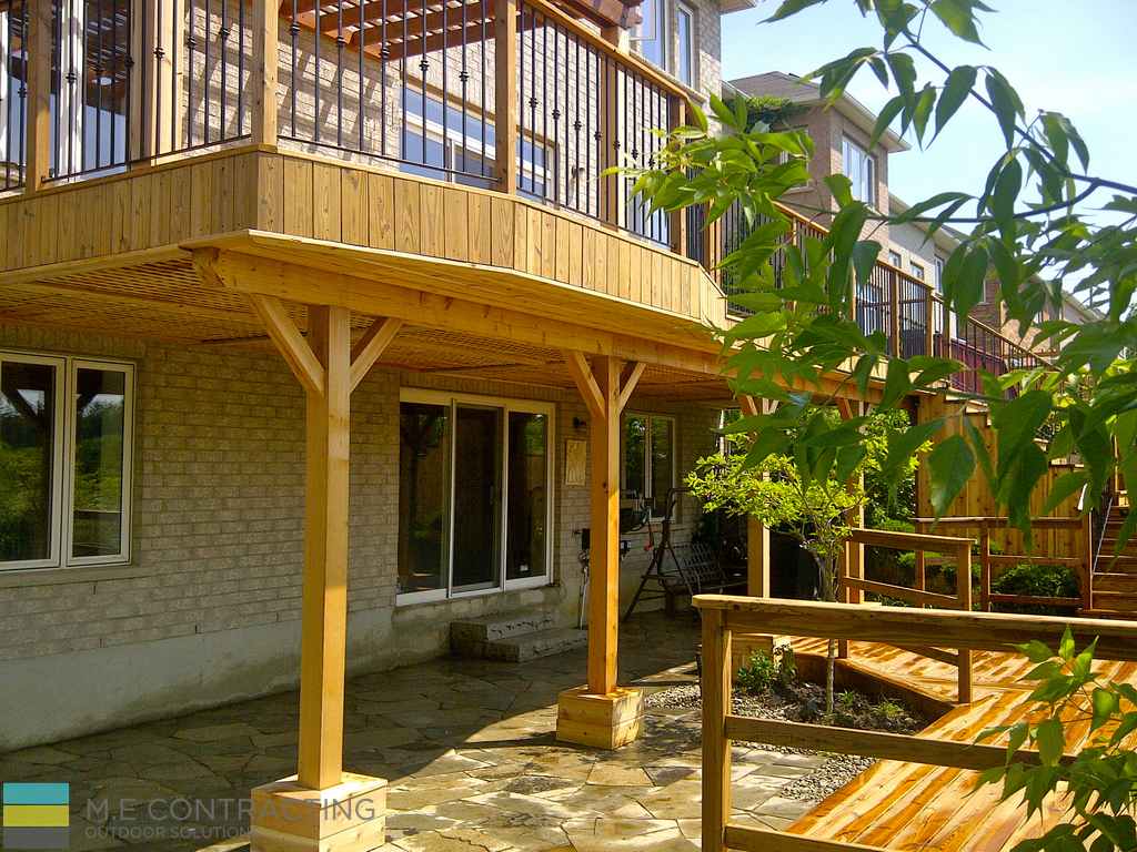 deck construction project featuring cedar deck and stone veneer by M.E. Contracting