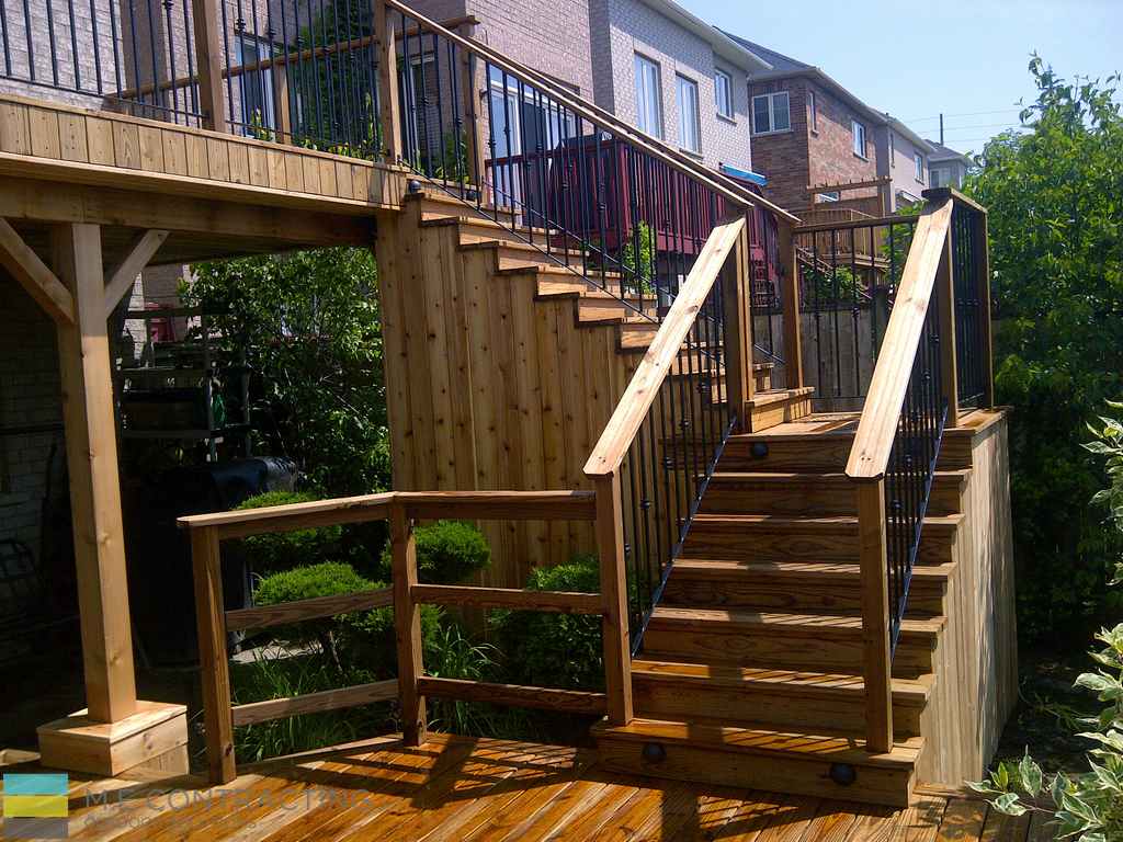 Landscaping project featuring Cedar Deck build over basement walkout by M.E Contracting