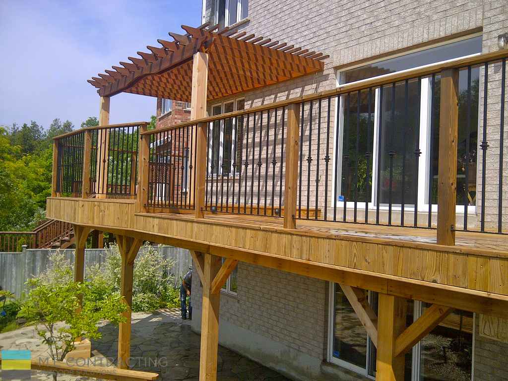 landscaping project featuring raised cedar deck with pergola built over it by M.E contracting