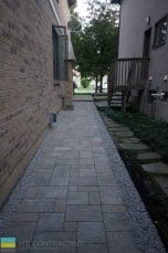 M.E. Contracting completed this interlocking walkway with stone pebbles and landscaping.