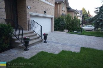 M.E. Contracting completed this driveway renovation including interlocking patio, stone steps and wrought iron railings.