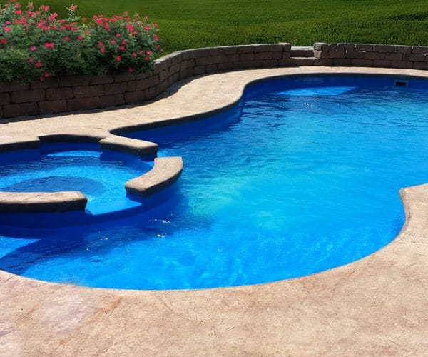 The Eclipse – In Ground Fiberglass Pool design with side spa and coping