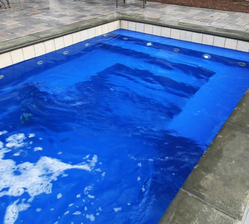 Palladium Plunge Fiberglass Pool with water feature design by M.E. contracting