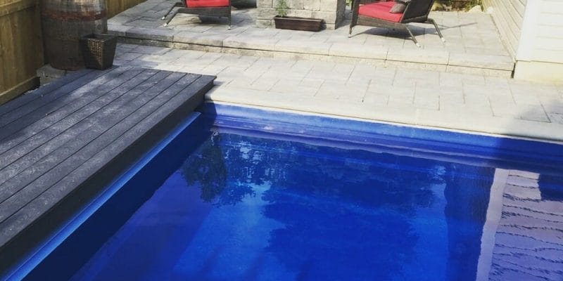 Leisure fiberglass pool installation with PVC deck build