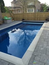 Pool with stone edging and interlocking patio